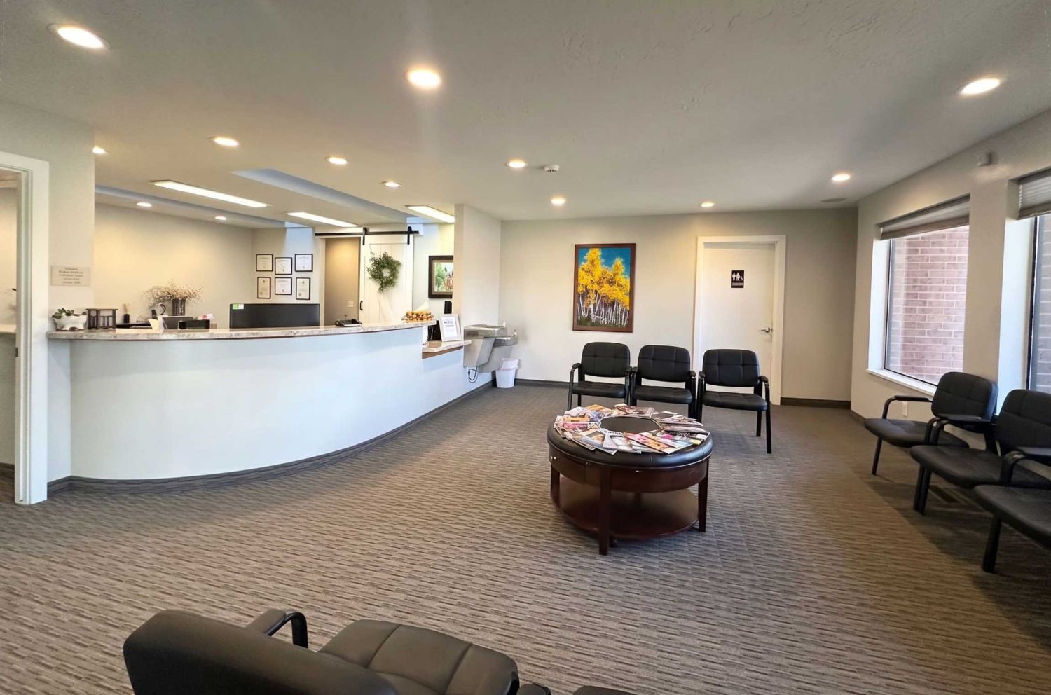 The waiting room and front desk inside Ashley Valley Family Dental